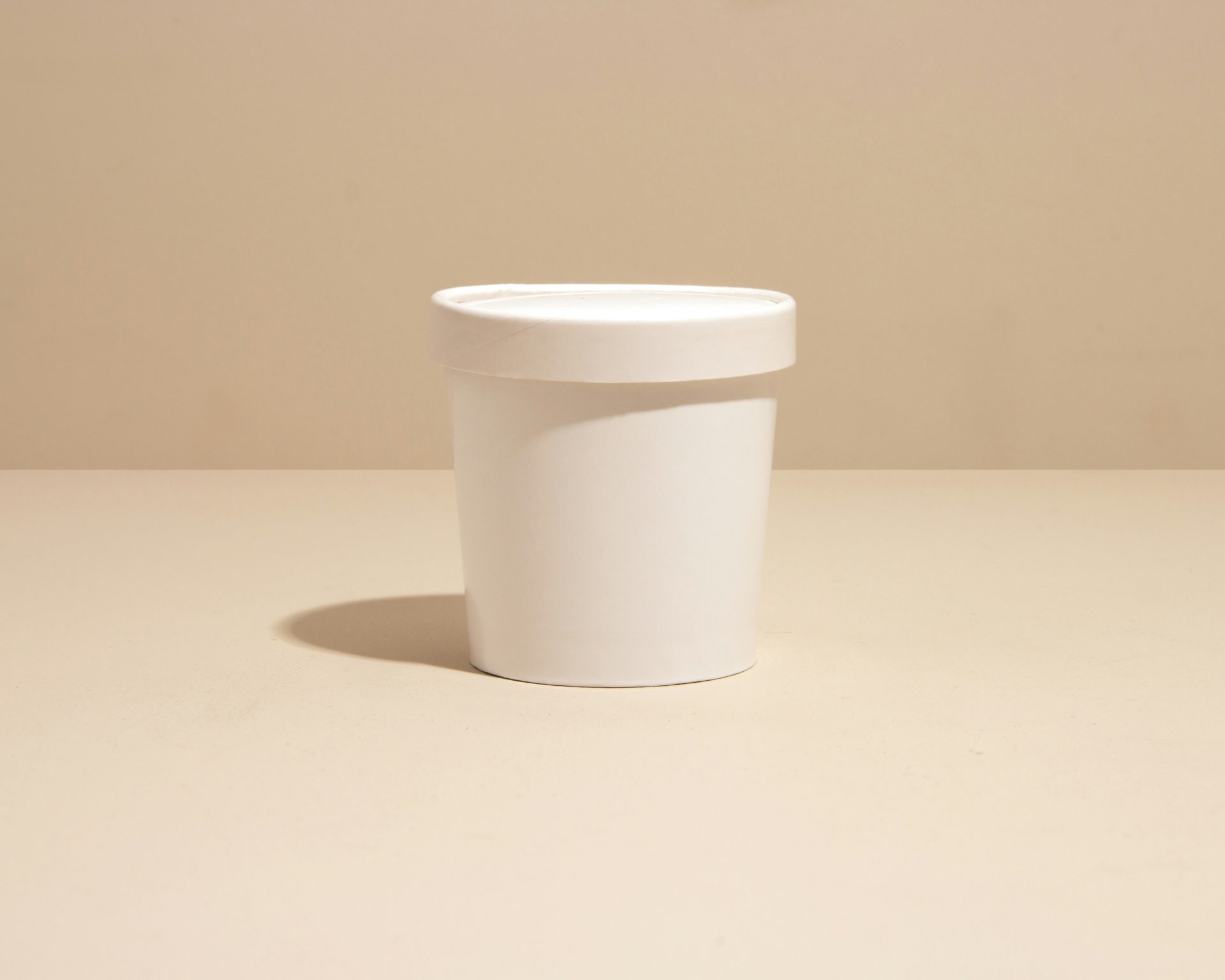 a white cup sitting on top of a table